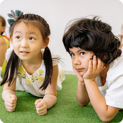 Kids laying on grass